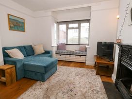 A living room with a sofa and television at Garden Retreat in Swanage