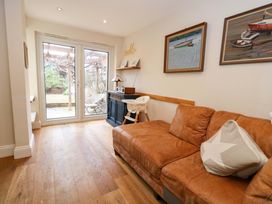 A living room with a couch and window at Garden Retreat in Swanage