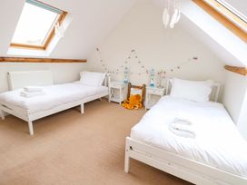 A bedroom with two beds and nightstands at Garden Retreat in Swanage
