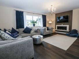 A living room with a sofa and television at Tyn Y Coed