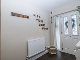 A hallway with a coat rack and basket at Tyn Y Coed