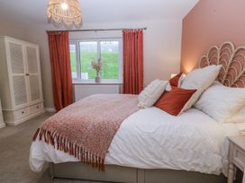A bedroom with a bed and curtains at Tyn Y Coed 