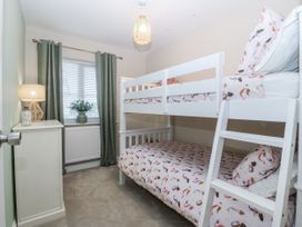 A bedroom with a bunk bed and lamp at Tyn Y Coed in 