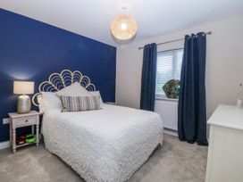 A bedroom with a bed and a lamp on a nightstand at Tyn Y Coed 