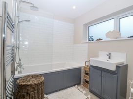 A bathroom with bathtub, shower and sink at Tyn Y Coed in 
