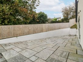 An outdoor area with paving stones and a fence at Tyn Y Coed