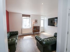 A living room with sofas and a TV at Number 33 in Scarborough