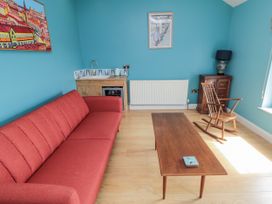 A living room with a red sofa and a coffee table at Number 33 Scarborough