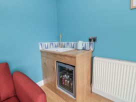A kitchenette with a sink and fridge at Number 33 Scarborough