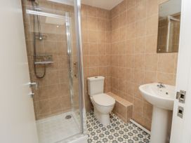 A bathroom with a shower, toilet, and sink at Number 33 Scarborough