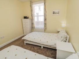 A bedroom with two beds and a dresser at Number 33 in Scarborough