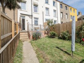 A garden with grass and stairs leading to a house at Number 33 in Scarborough