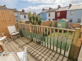 A balcony area with chairs and a view of a garden at Number 33 Scarborough