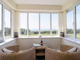 A conservatory with a view overlooking the sea at Ysgubor Newydd Parc Isaf Dyffryn Ardudwy