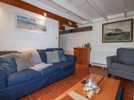 A living room with a sofa and coffee table at Rose Cottage in Falmouth