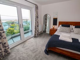 A bedroom with a bed and nightstand at Miramar in St. Ives