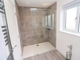A bathroom with a shower and towel radiator at Miramar in St. Ives