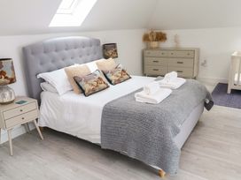 A bedroom with a bed and nightstand at Miramar in St. Ives