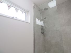 A bathroom featuring a shower with glass enclosure and a window at Miramar St. Ives