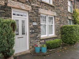 A front entrance of a cottage with plants at Lily Cottage in Windermere