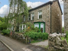 A house with stone exterior and greenery at 28 Rock Villas in Carnforth