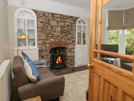 A living room with a fireplace and bookshelves at 28 Rock Villas in Carnforth