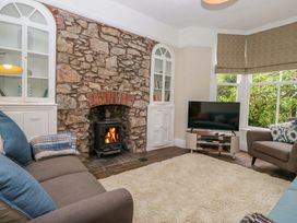 A living room with a fireplace and television at 28 Rock Villas Carnforth
