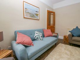 A living room with a sofa and a picture on the wall at 28 Rock Villas in Carnforth