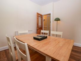 A dining room with a wooden table and chairs at 28 Rock Villas in Carnforth