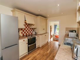 A kitchen with cabinets and appliances at 28 Rock Villas in Carnforth