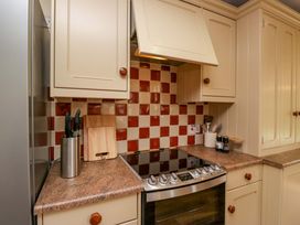 A kitchen with cabinets and a stove at 28 Rock Villas in Carnforth