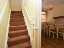 Stairs leading to a dining area with a table and chairs at 28 Rock Villas Carnforth