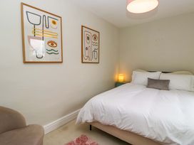 A bedroom with a bed and wall art at 28 Rock Villas, Carnforth