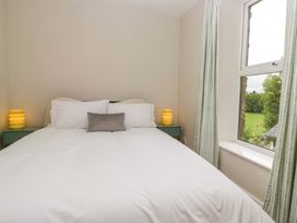 A bedroom with a bed and lamp at 28 Rock Villas in Carnforth