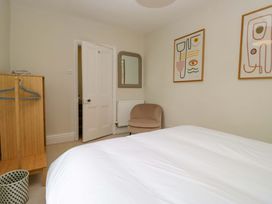 A bedroom with a bed and armchair at 28 Rock Villas in Carnforth