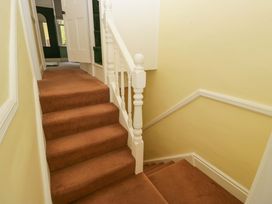 A staircase with a carpet and handrail at 28 Rock Villas in Carnforth