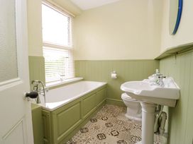 A bathroom with a bathtub and sink at 28 Rock Villas in Carnforth