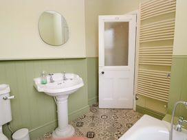 A bathroom with a sink, toilet, and a mirror at 28 Rock Villas Carnforth