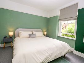 A bedroom with a bed and two bedside lamps at 28 Rock Villas in Carnforth