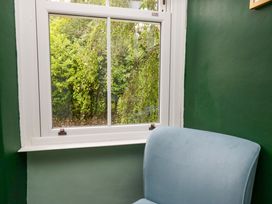 A snug with a chair and a window showing greenery at 28 Rock Villas in Carnforth