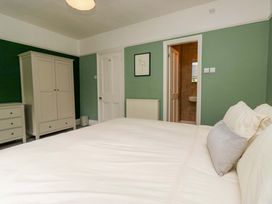 A bedroom with a bed and wardrobe at 28 Rock Villas, Carnforth
