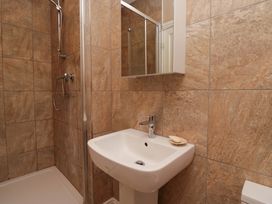 A bathroom with a shower and sink at 28 Rock Villas in Carnforth