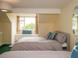 A bedroom with two beds and a window at 28 Rock Villas, Carnforth