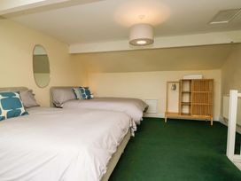 A bedroom with two beds and a shelf at 28 Rock Villas Carnforth