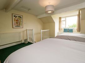 A bedroom with two beds and a window at 28 Rock Villas in Carnforth