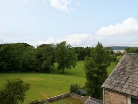A view of trees and a grassy field at 28 Rock Villas in Carnforth