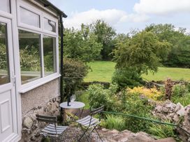 A garden with a table and chairs at 28 Rock Villas in Carnforth