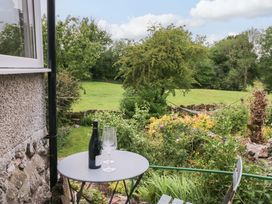A table with a bottle and glasses in a garden at 28 Rock Villas Carnforth