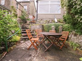 A garden with a table and chairs at 28 Rock Villas in Carnforth
