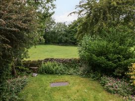 A garden with grass and trees at 28 Rock Villas Carnforth